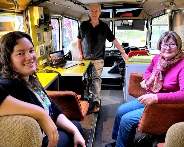 Three people onboard the digital Learning Bus.